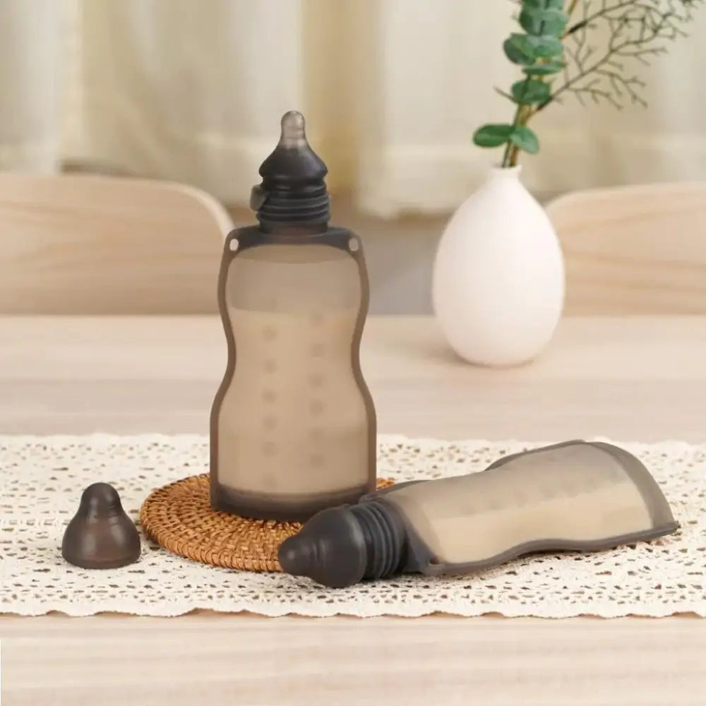 Soft gray Silicone baby bottles from Toshi Baby Romper deal with Haakaa Squeeze and Odyssey Wagon Wheels