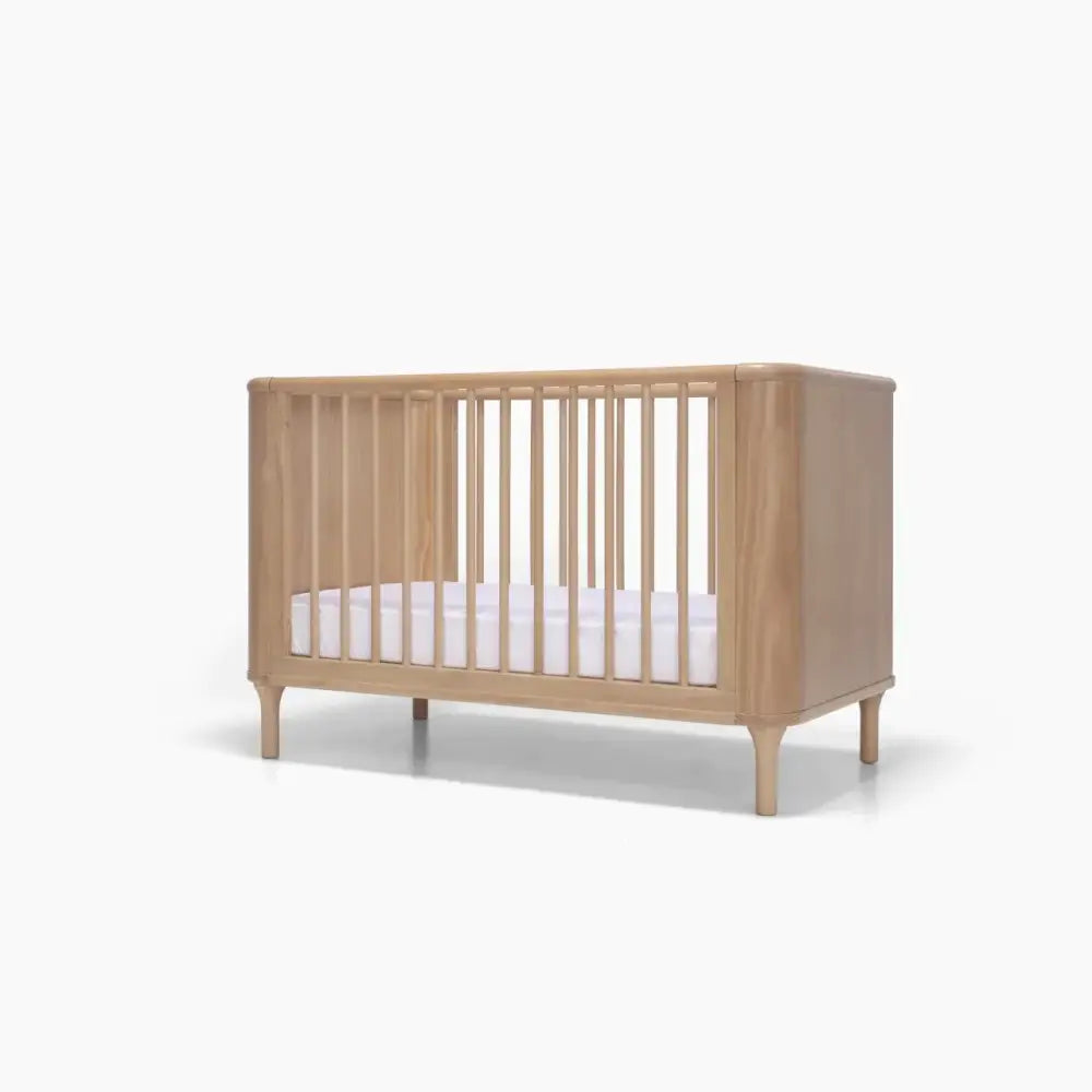 Wooden baby crib with white mattress from Tasman Eco Willow 3 Pc Package featuring willow 3-drawer chest and pocket spring mattress