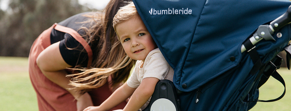 Blue Bumbleride Indie Stroller with a kid wearing Toshi Baby Romper for baby strollers