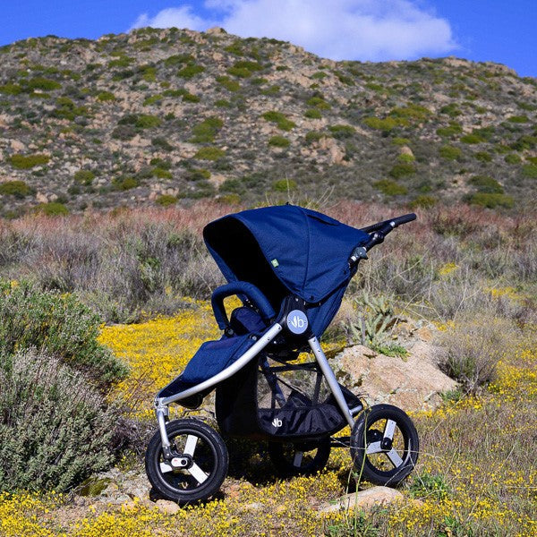 Navy blue Bumbleride Indie Stroller on Odyssey wagon wheels for Toshi baby romper fun