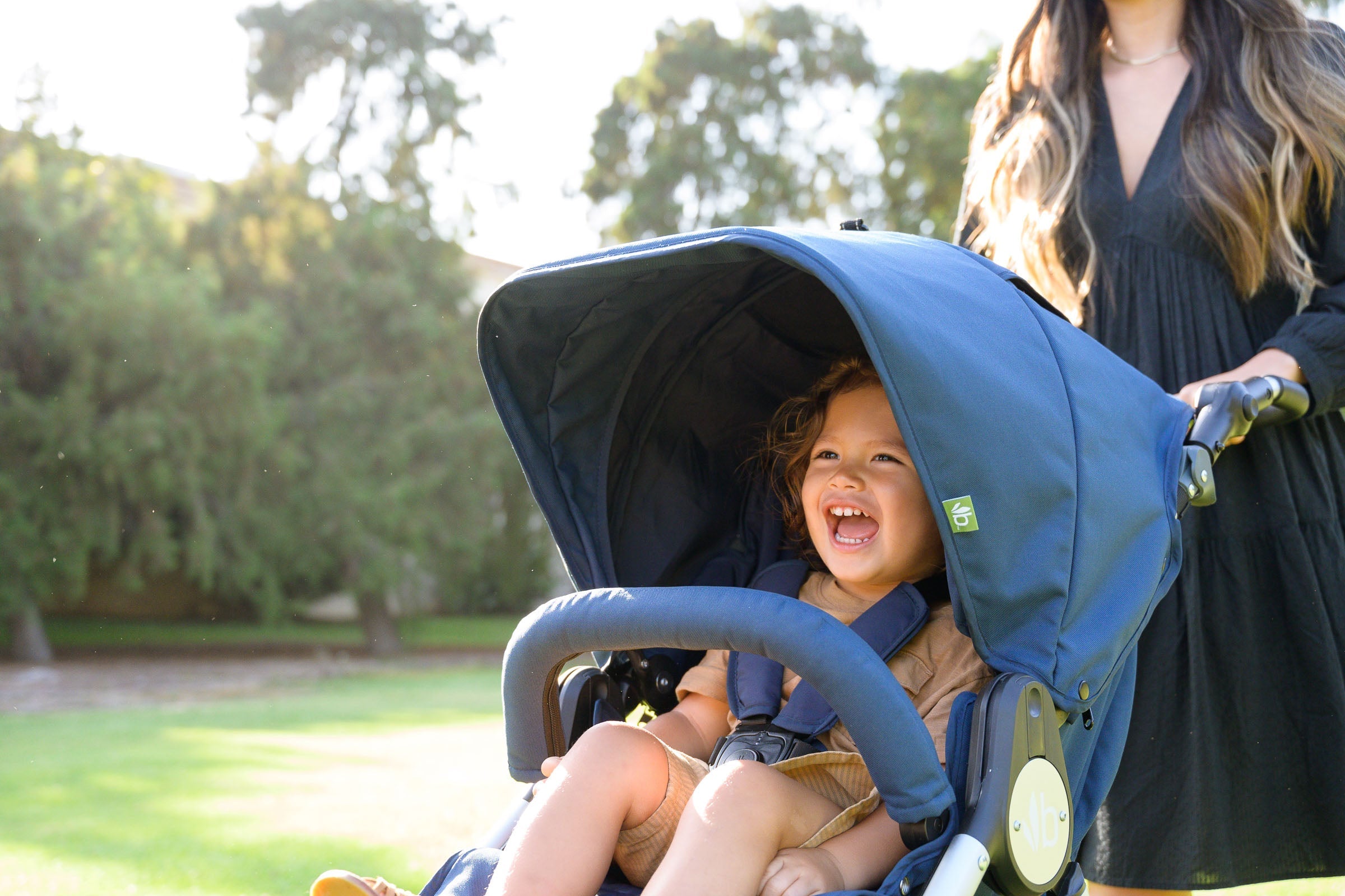 Blue Bumbleride Indie Stroller with Odyssey Wagon Wheels and Toshi Baby Romper style