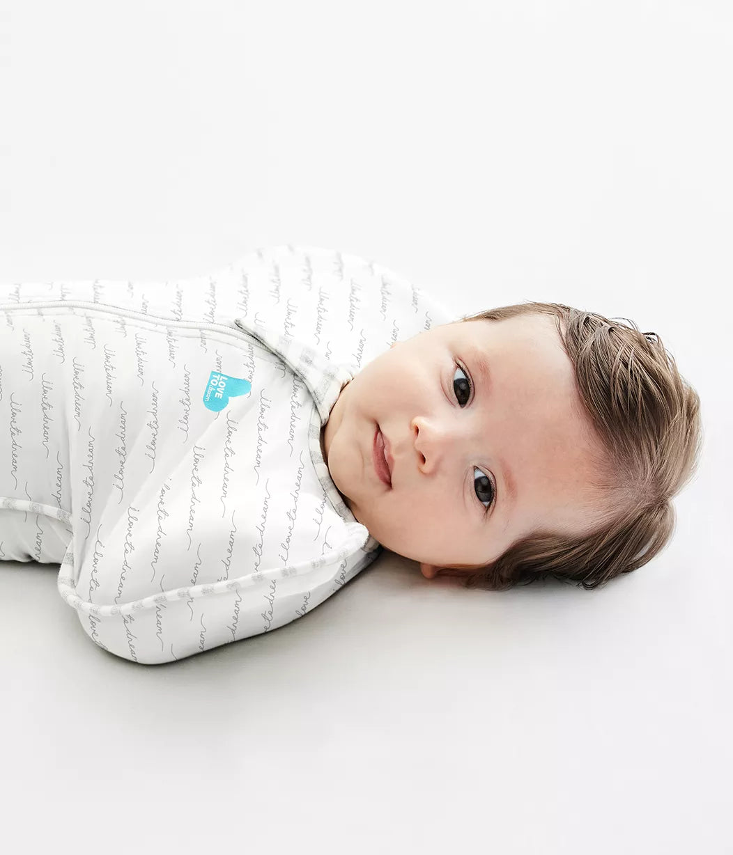 Swaddled brown-haired baby with arms up™ in Love To Dream Swaddle Up 1.0TOG
