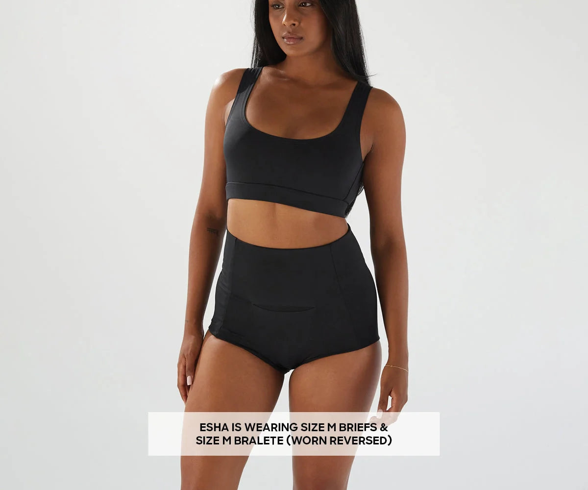Woman in black bralette and briefs showcasing Bare Mum Postpartum briefs during Toshi Baby Romper odyssey wagon wheels