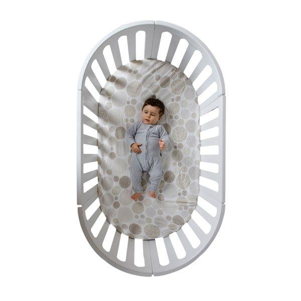 Oval white baby crib in Cocoon Nest Cot with mattress, a beautifully designed piece for bare mum postpartum peace