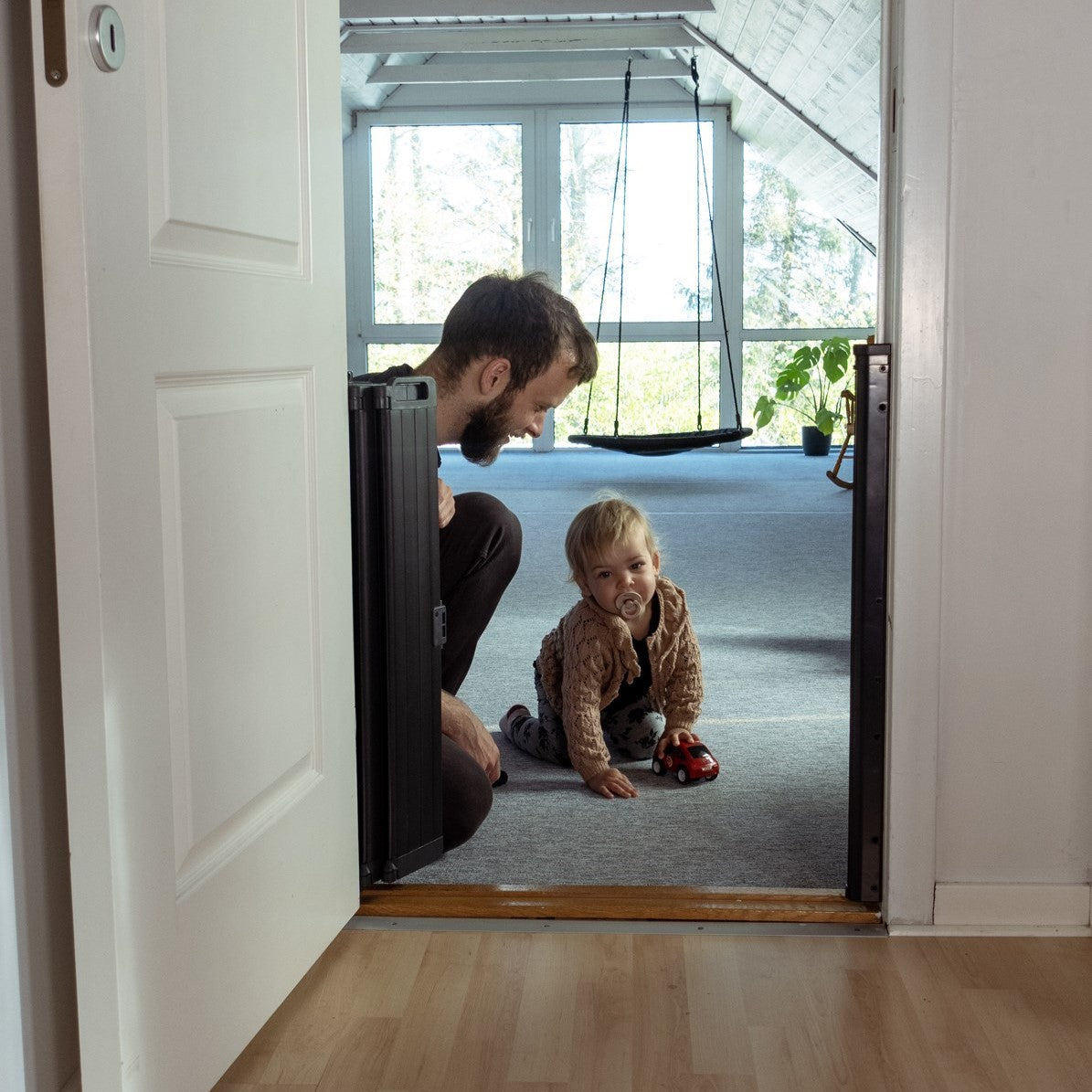 BabyDan Guard Me Gate Black is a sleek retractable baby gate for safe home spaces