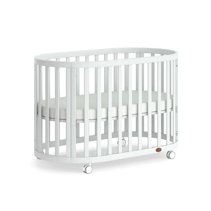 White oval Boori Eden Oval Cot with wheels and pocket spring mattress for babies
