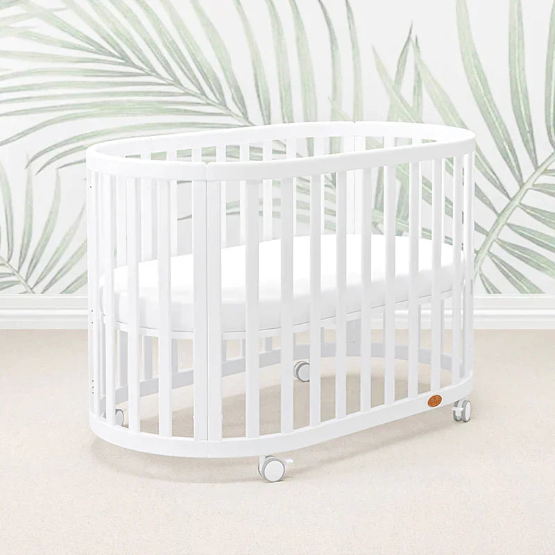 White oval Boori Eden Oval cot with wheels and pocket spring mattress for babies
