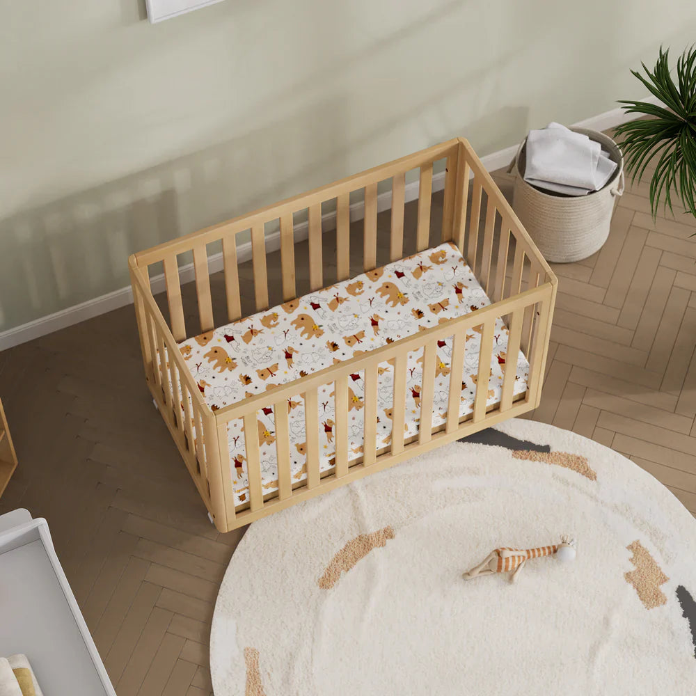 Wooden baby crib with dinosaur-themed bedding from Boori Turin Compact Cot plus pocket spring mattress