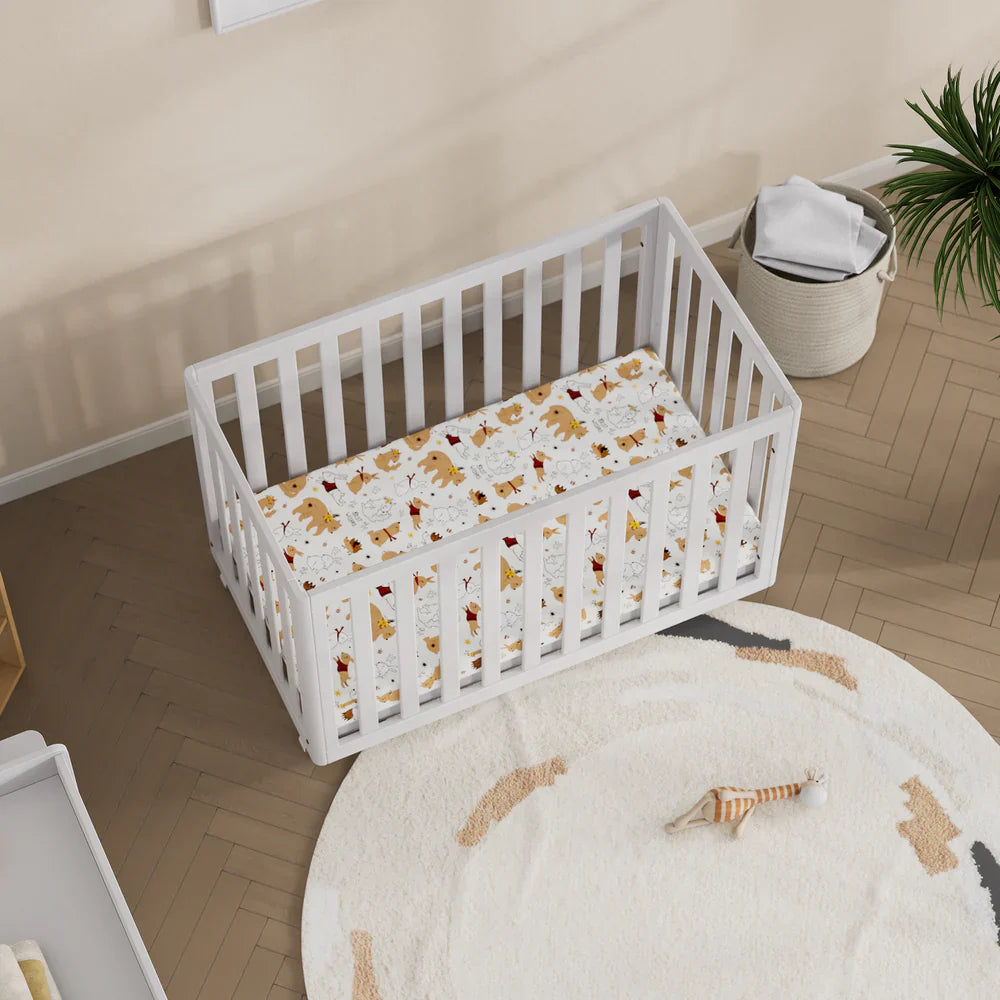 White wooden Boori Turin Compact Cot with patterned sheet and pocket spring mattress