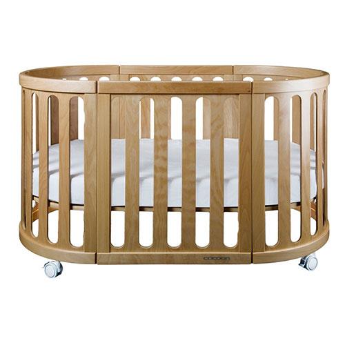 Oval wooden baby crib with wheels from Cocoon Nest Natural, perfect junior bed for Toshi Baby
