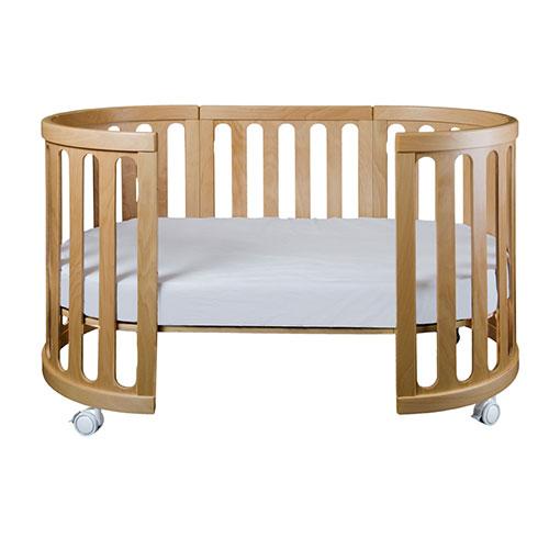 Oval wooden baby crib with wheels from Cocoon Nest Natural, perfect junior bed for Toshi Baby