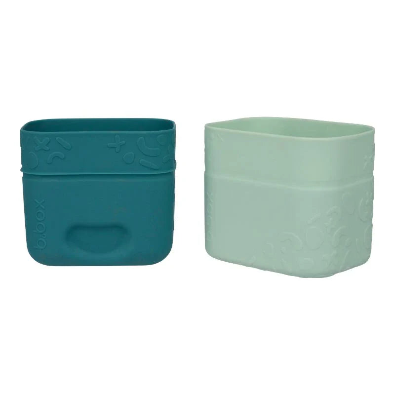 Two square silicone snack cups from Toshi Baby for easy snacking and reduce reliance on plastic
