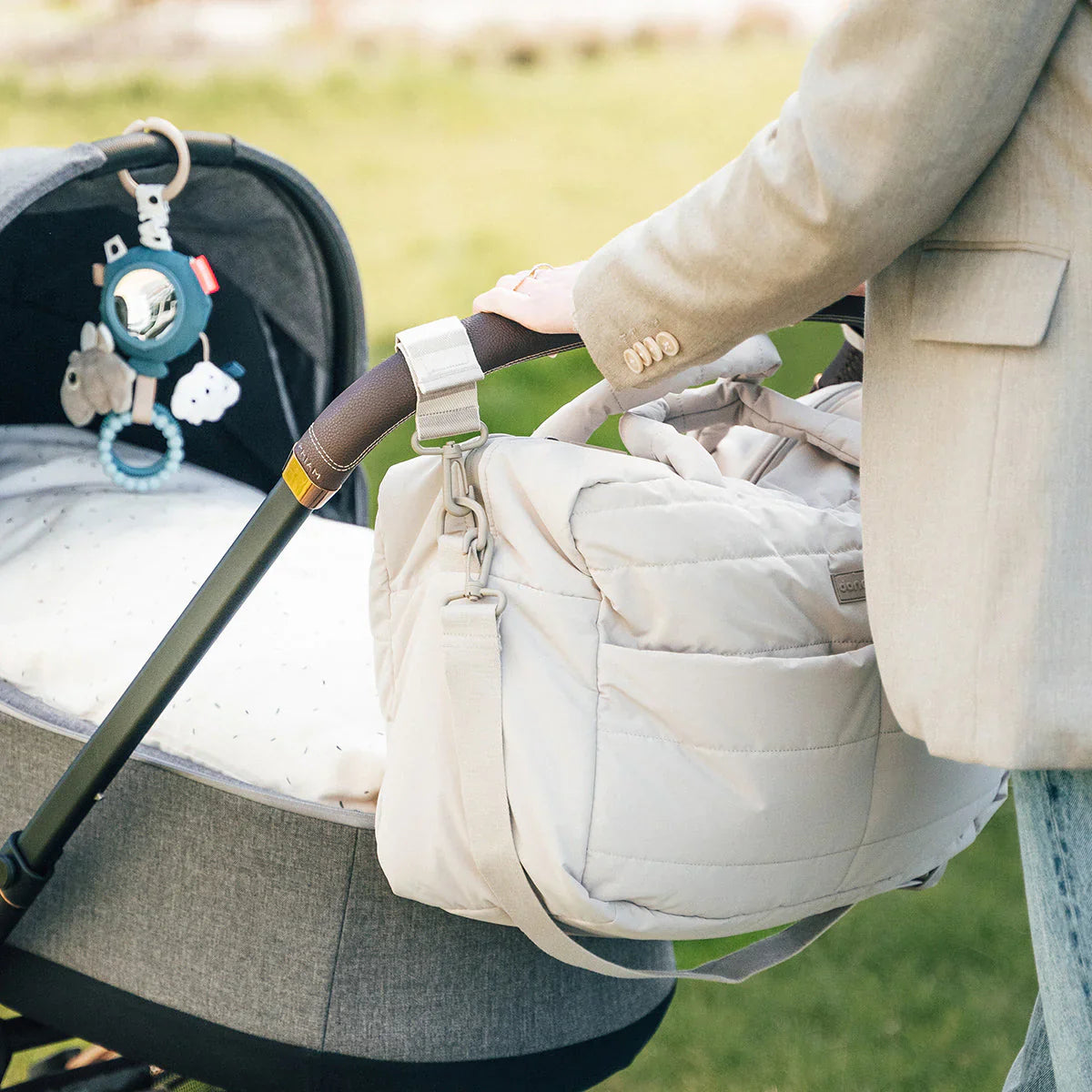 Beige deer quilted changing bag with exterior zip closure and interior insulated pocket