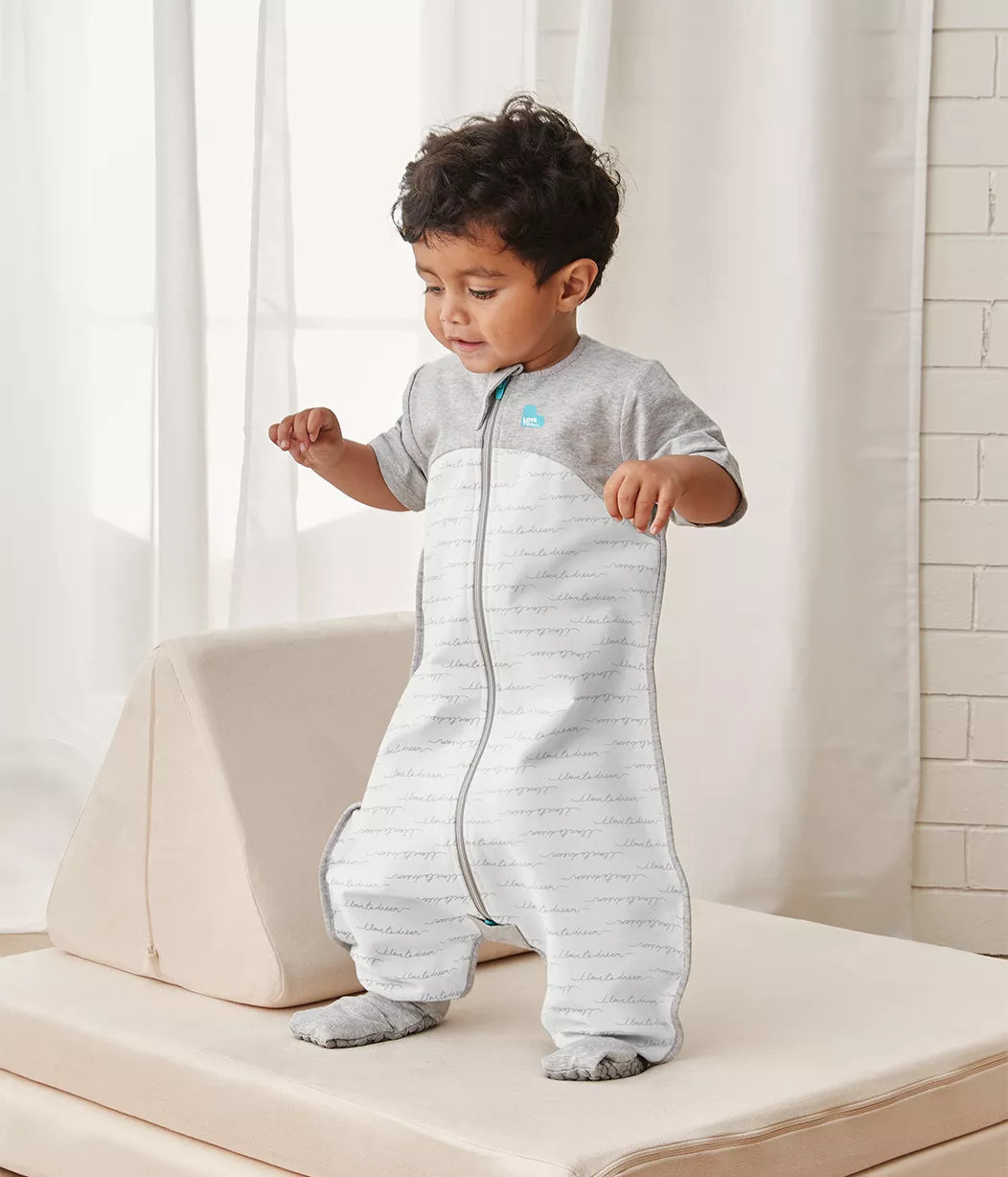 Cute toddler in a gray and white love to dream sleep suit, perfect for baby strollers