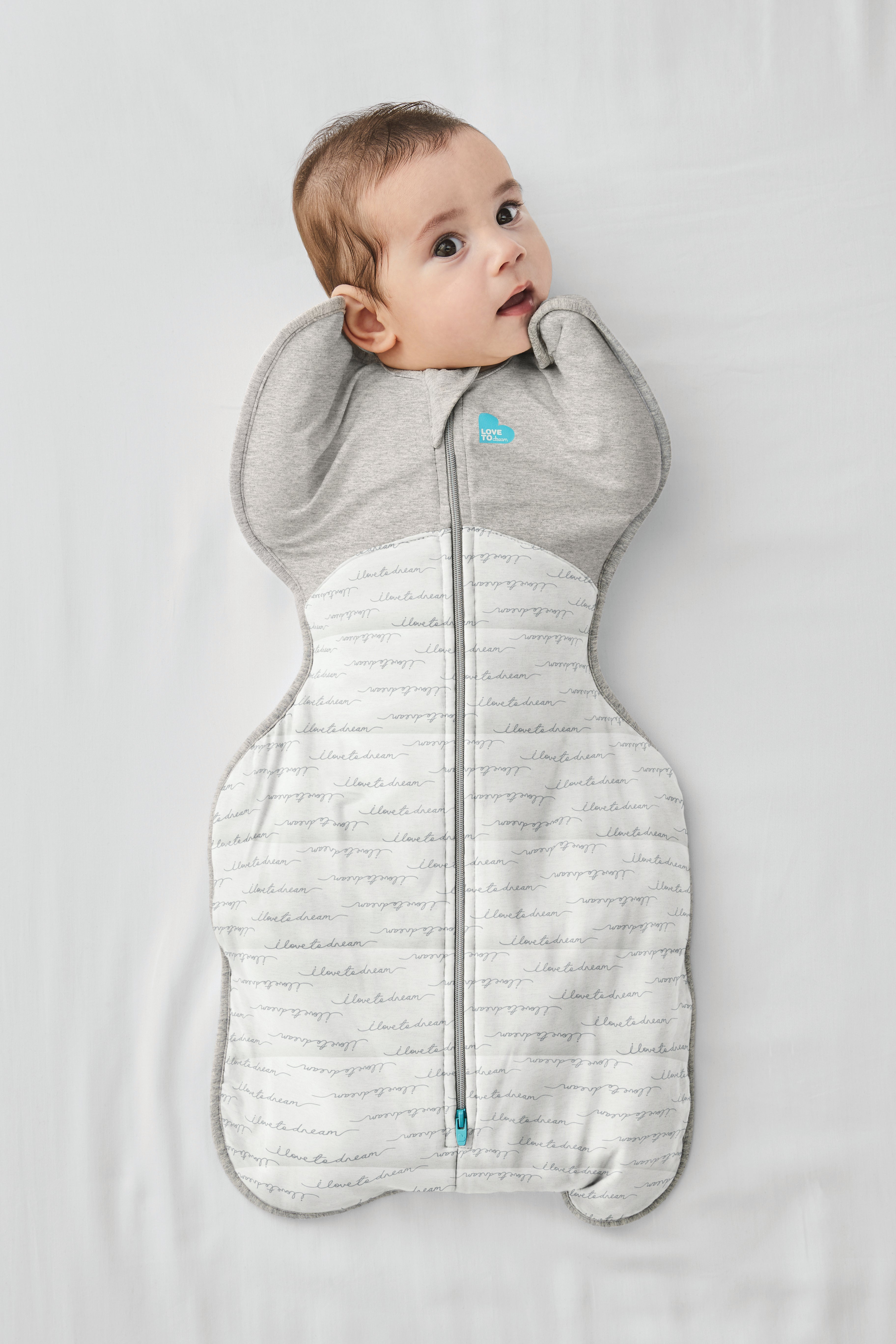 Baby in a gray and white dream swaddle, perfect for toshi baby naps