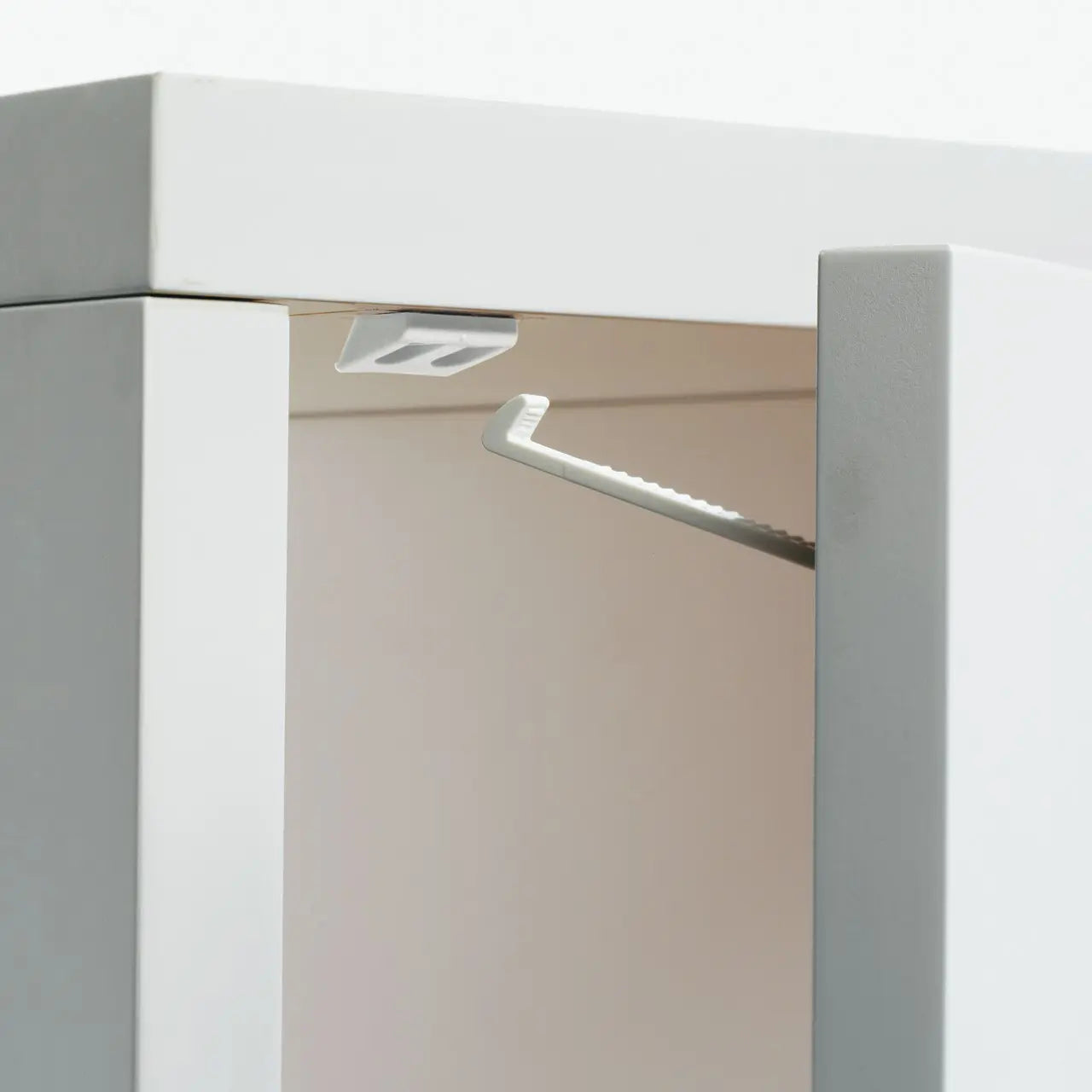 White cabinet with interior lighting showcasing Babydan Drawer Easy Fix for Toshi Baby