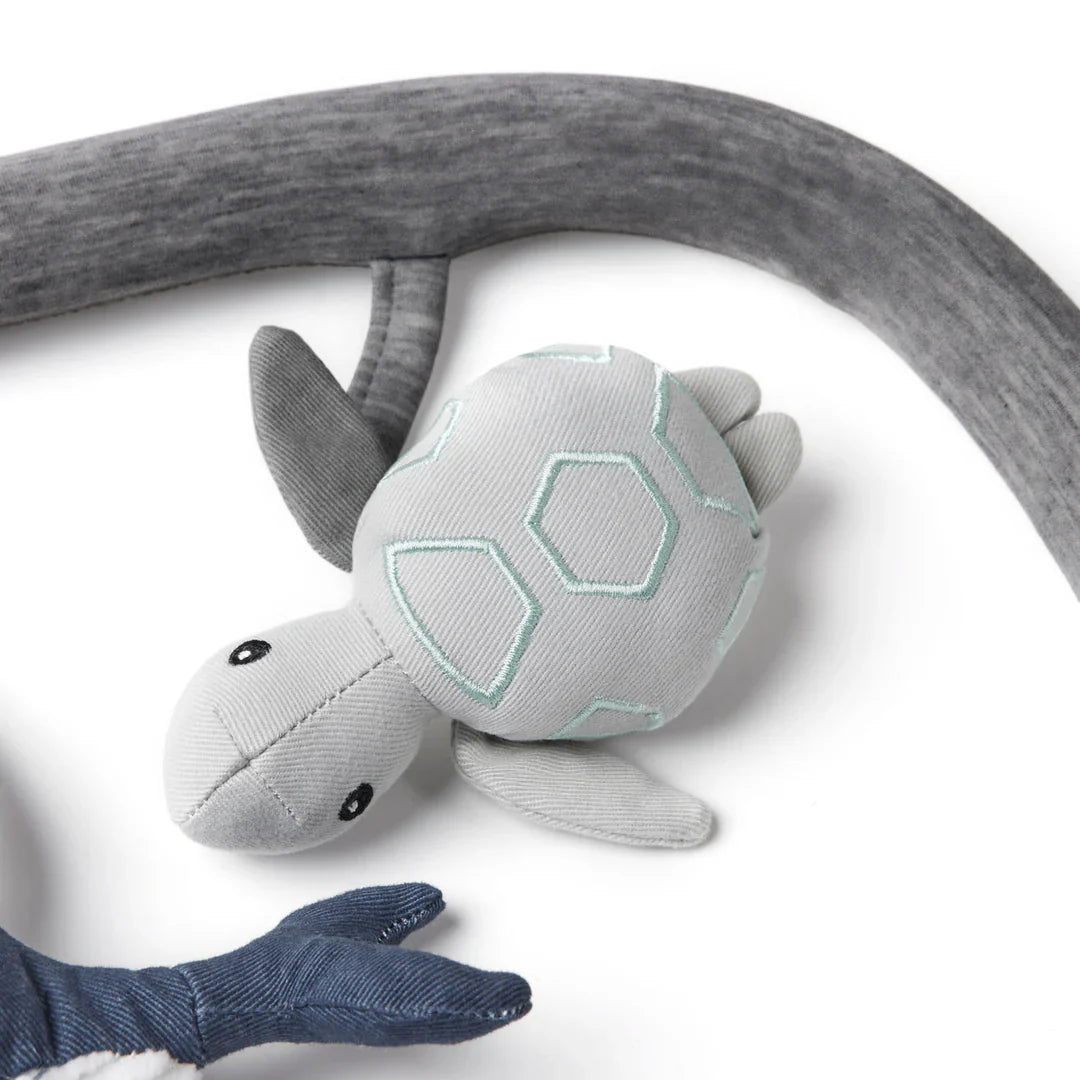 Gray plush turtle toy from Ergobaby Evolve Ocean Wonders ultimate bouncer toy