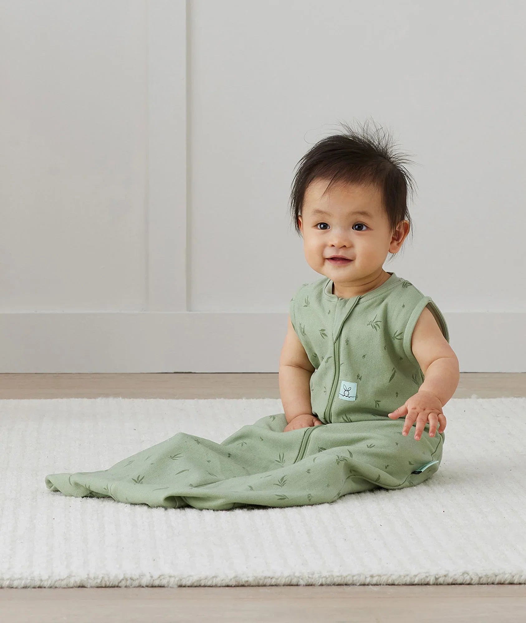 Cute baby in green ergopouch jersey sleeping bag perfect for baby strollers and naps