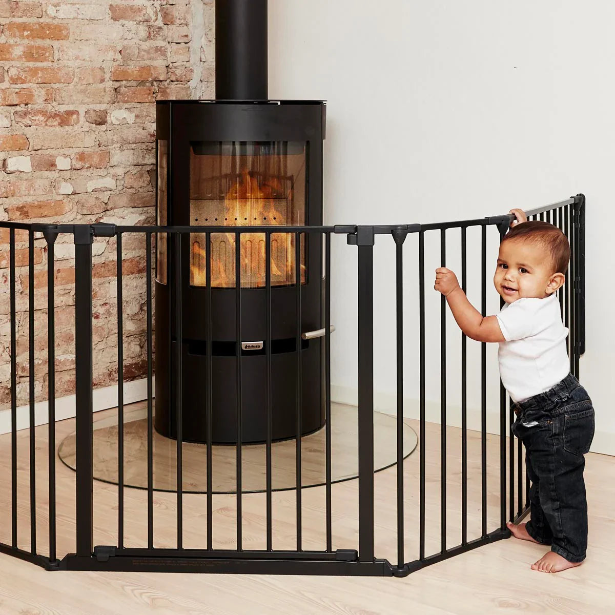 Black metal fireplace safety gate with Flex Configure and Toshi Baby wall mounting kit