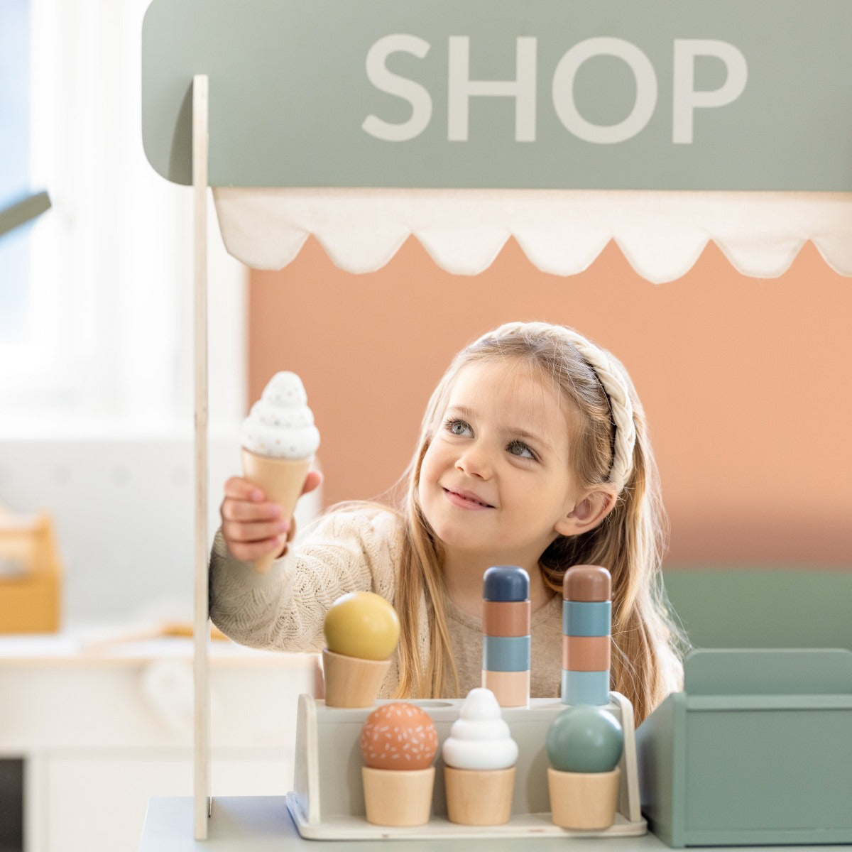 Child’s ice cream shop playset from Flexa Shop and Cafe with toshi baby romper fun