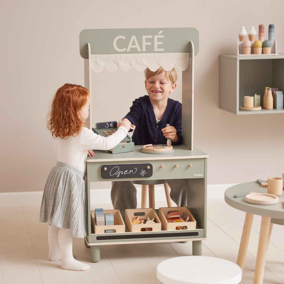 Wooden toy cafe from Flexa Shop and Cafe with odyssey wagon wheels and Toshi baby romper
