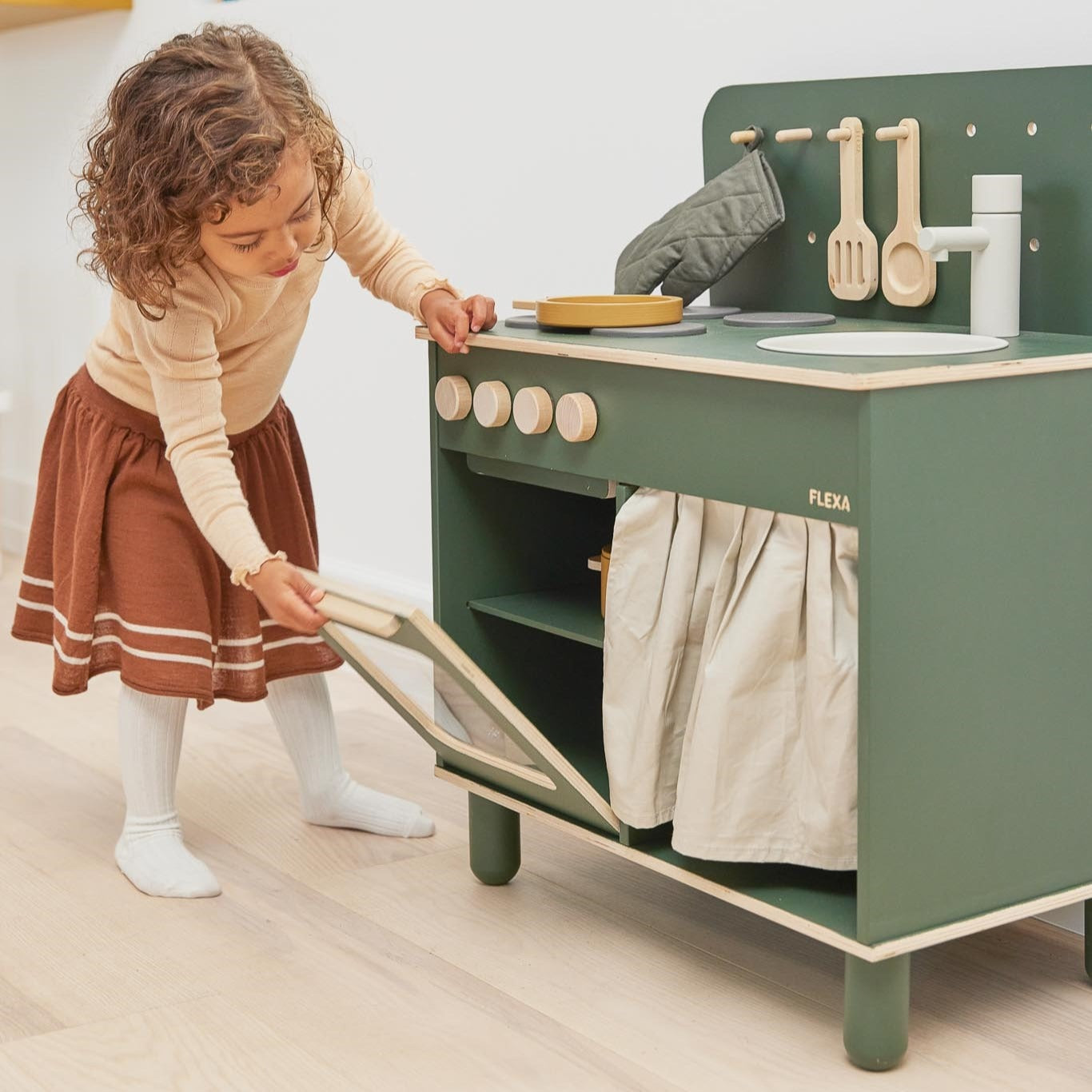 Green wooden toy kitchen from Flexa Kitchen, perfect for imaginative play with baby strollers and more