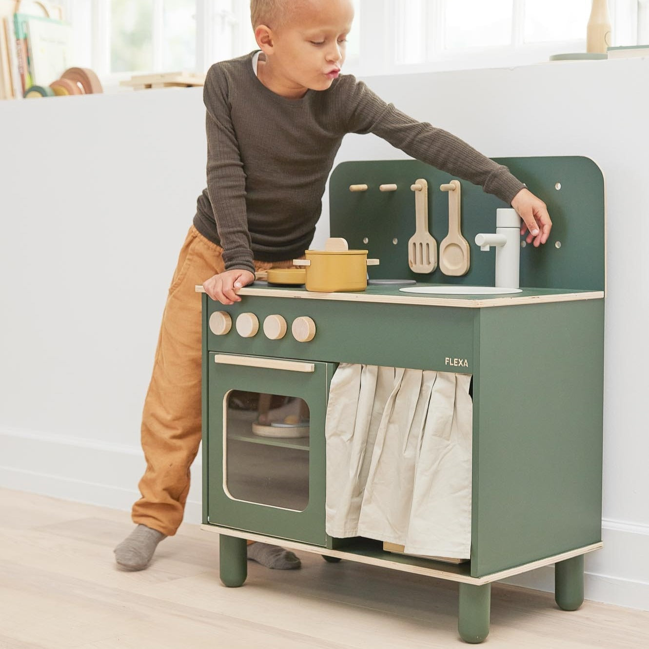 Green wooden toy kitchen from Flexa Kitchen, perfect for toddler playtime