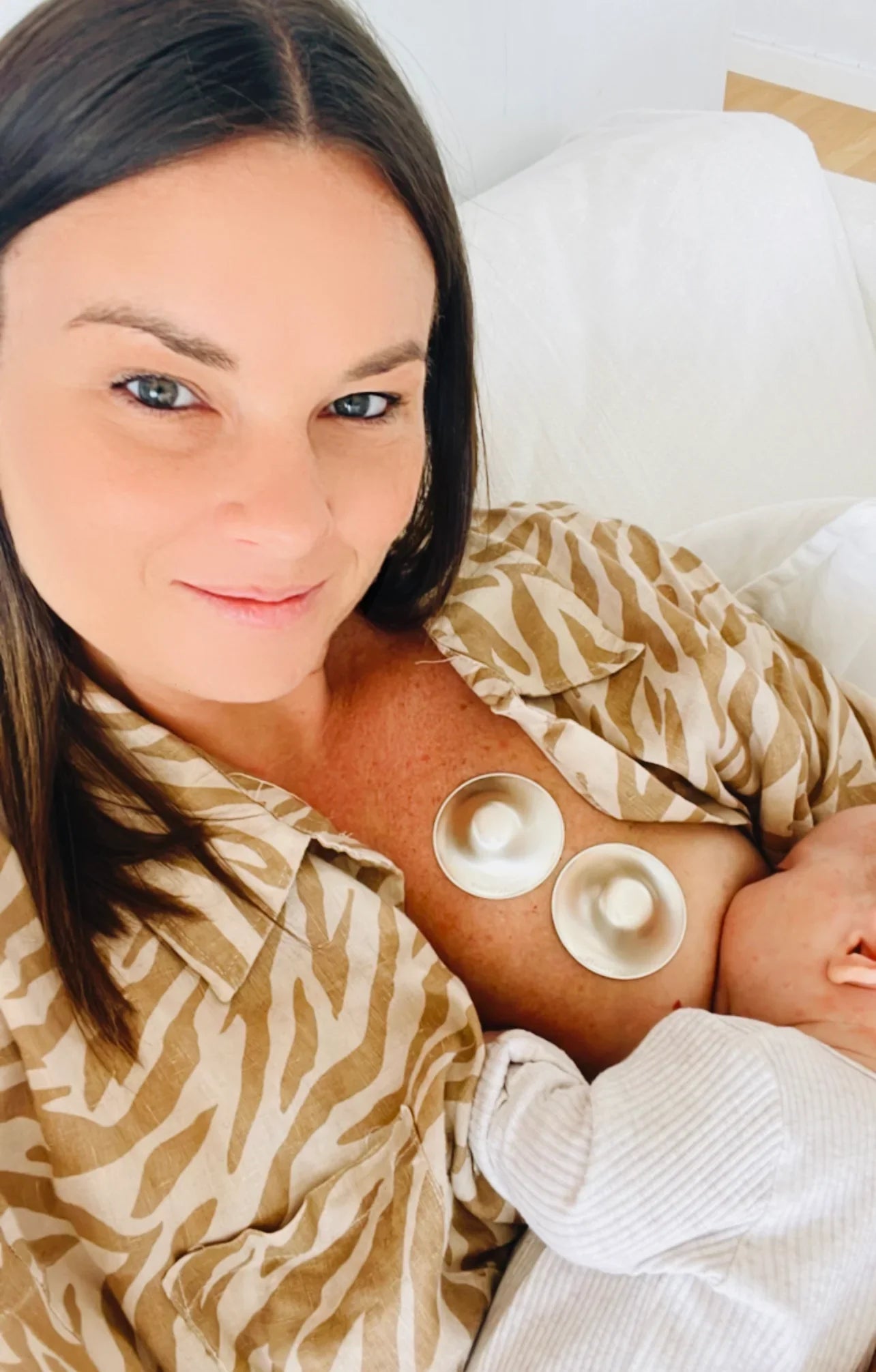 Breastfeeding mom using lactivate silver nursing cups to heal sore damaged nipples