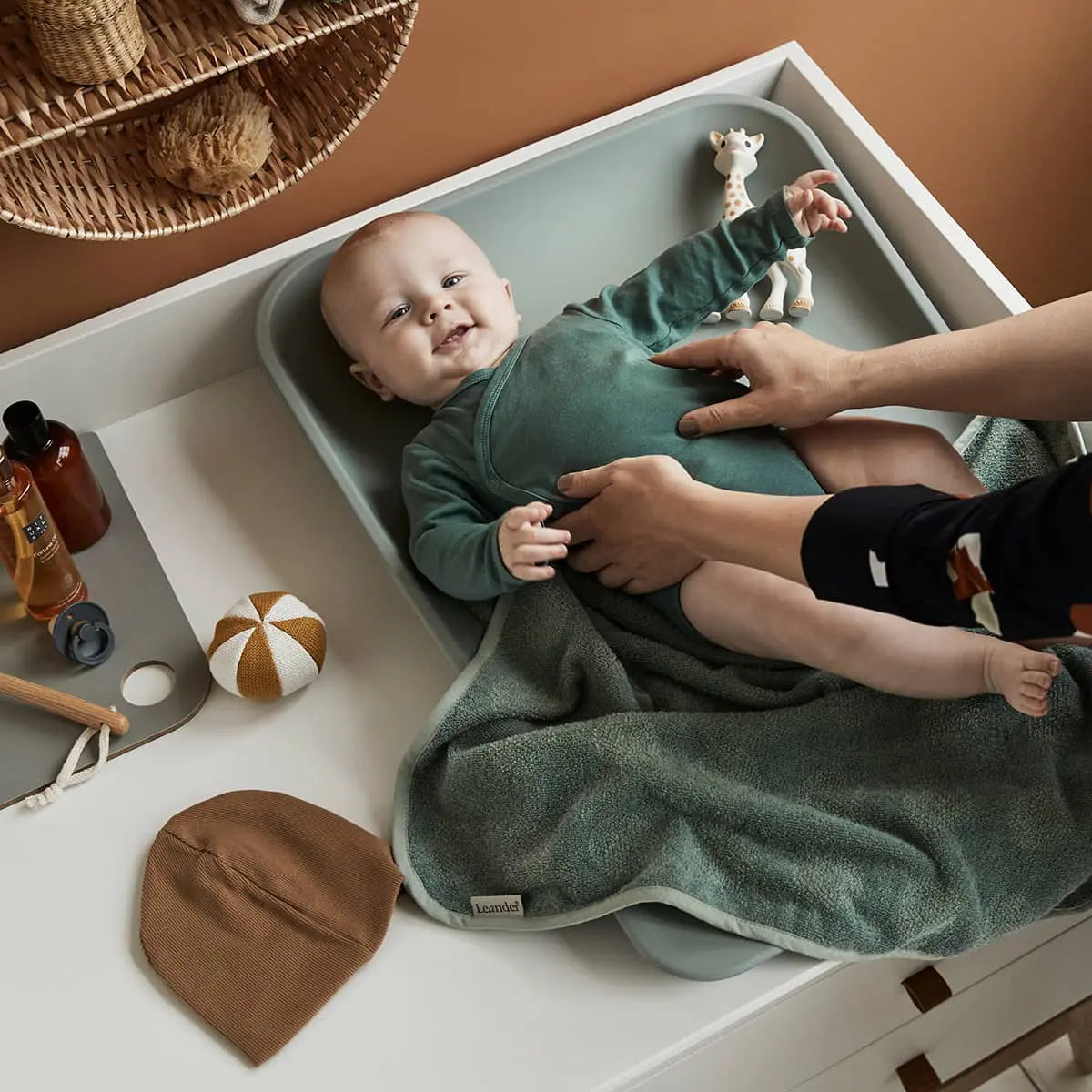 Baby on changing table using Toshi Baby Leander Matty Change Mat Sage Green style