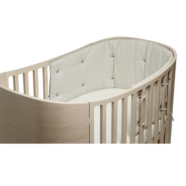 Organic Classic Cot Bumper in an oval wooden baby crib with padded bumper for Toshi Baby