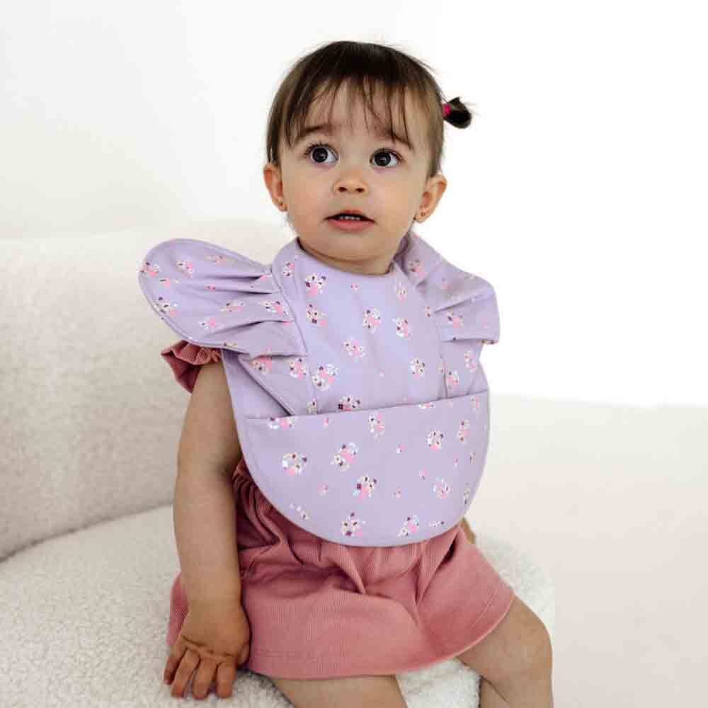 Baby wearing a Lilac Bloom Frill Snuggle Bib perfect for baby strollers and style