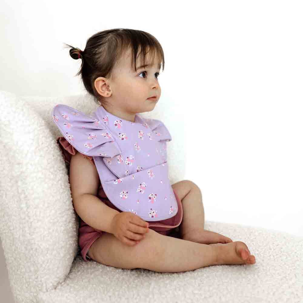 Baby wearing the cute Lilac Bloom Frill Snuggle Bib perfect for baby strollers