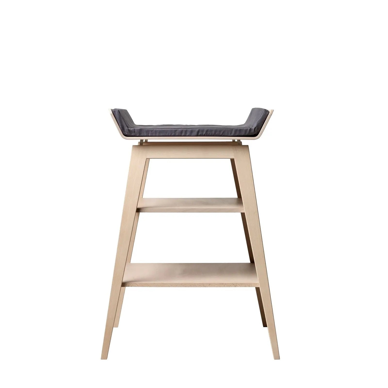 Linea Change Table by Toshi Baby with wooden stool, gray cushion, and shelves