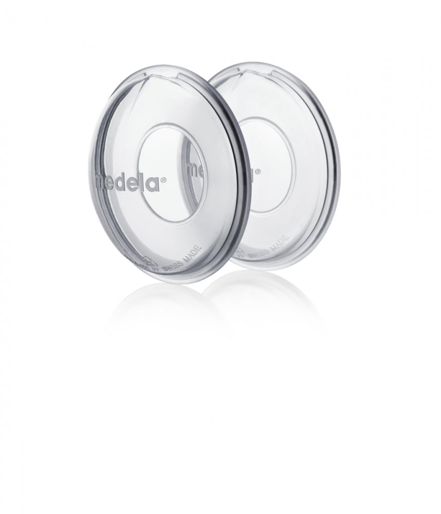 Clear Medela milk collection shells for leaking breast milk, perfect with Toshi baby romper