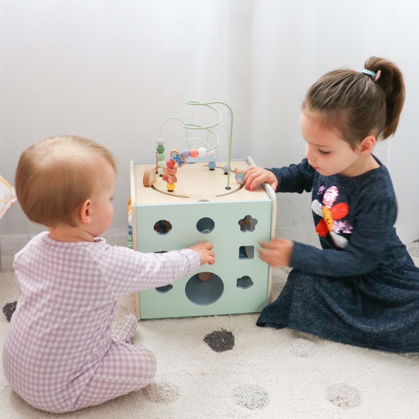 Children playing with the Moover Toys Giant Activity Cube in light green for Toshi Baby