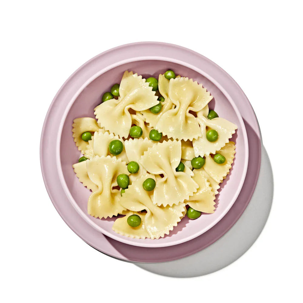 Bow tie pasta with peas in OXO Tot Stick & Stay Suction Bowl for easy feeding