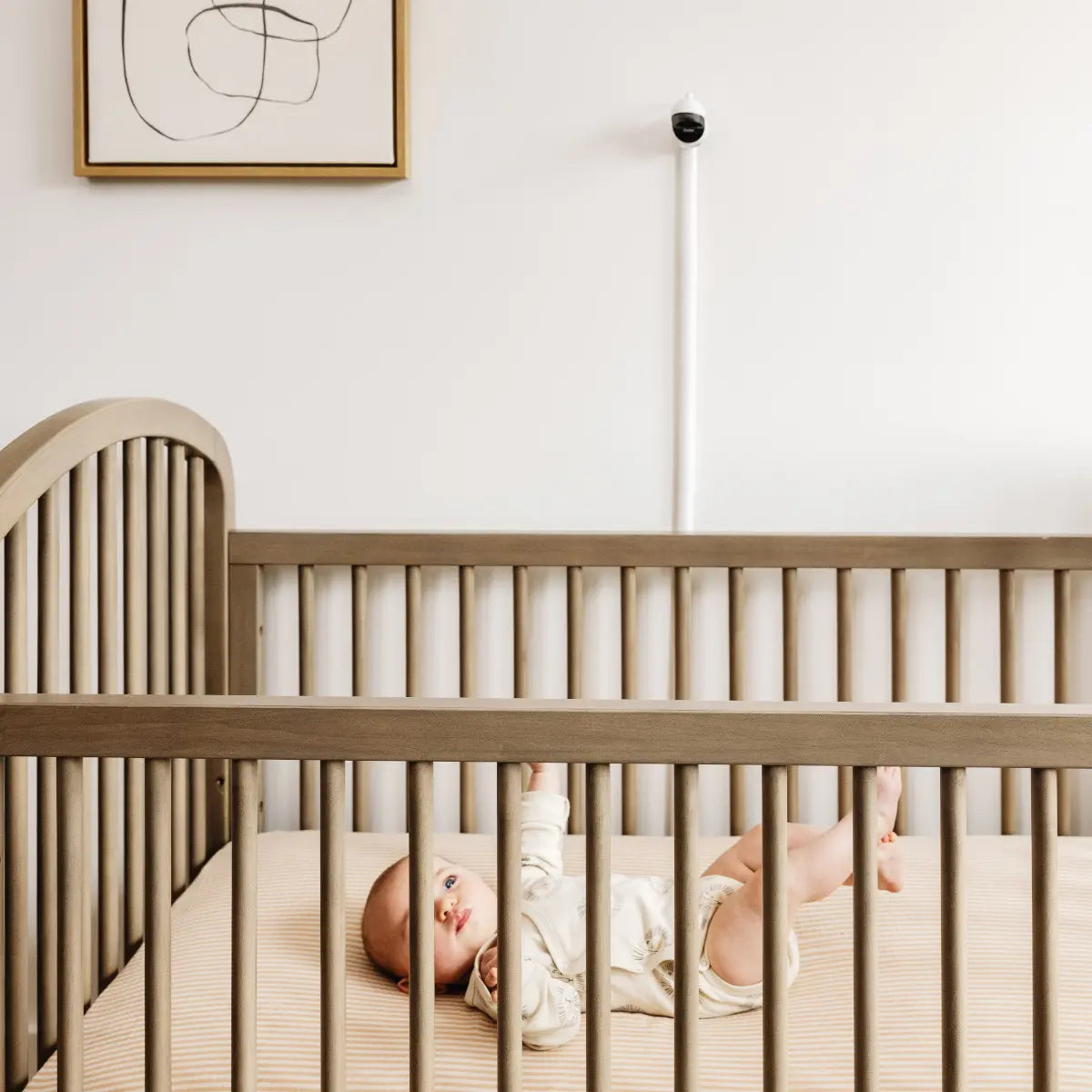 Baby in crib with Owlet Cam 2 White, wearing toshi baby romper, perfect for bare mum postpartum