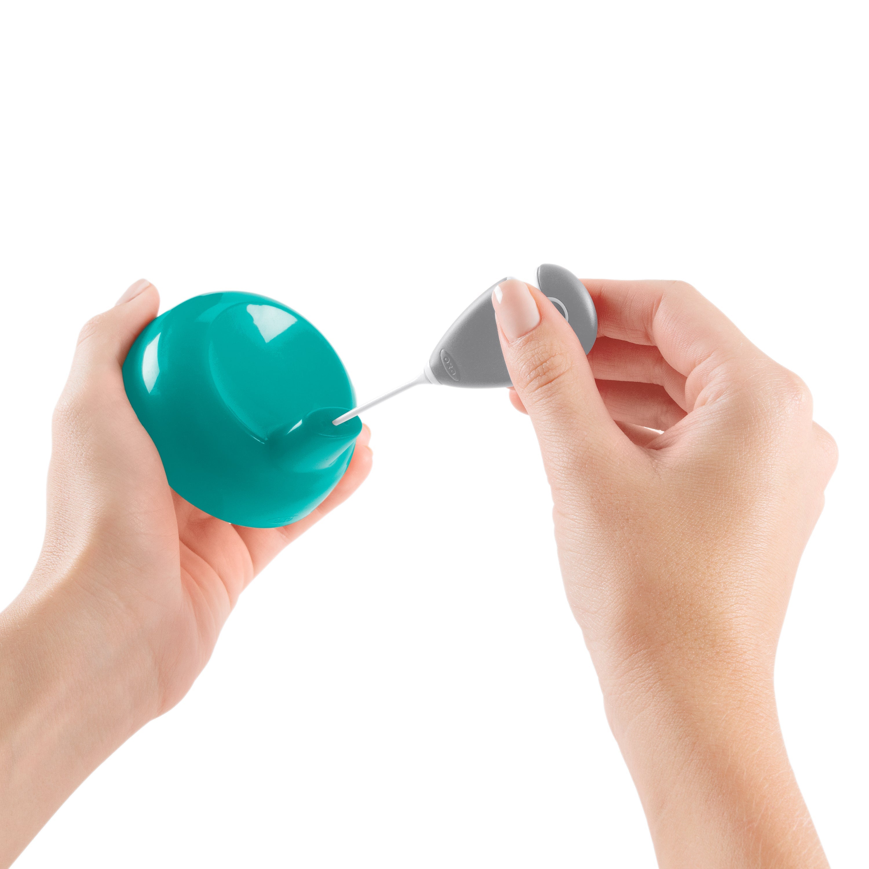 Teal and gray handheld milk frother with Oxo Tot Easy Cups for baby’s drinks