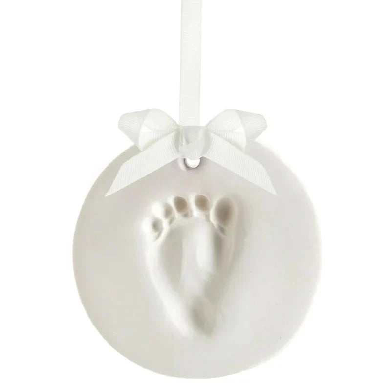 White baby footprint ornament from Pearhead Babyprints Keepsake, perfect for Toshi Baby fans