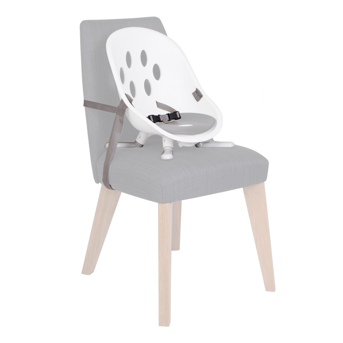 White and gray booster seat attached to a gray chair in Phil&Teds poppy modes kit scene