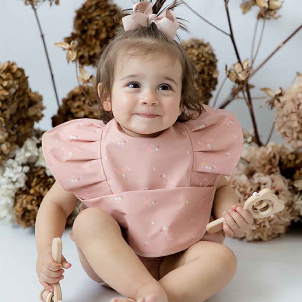 Baby wearing a pink Daisy Frill Snuggle Bib from Snuggle Hunny Toshi Baby