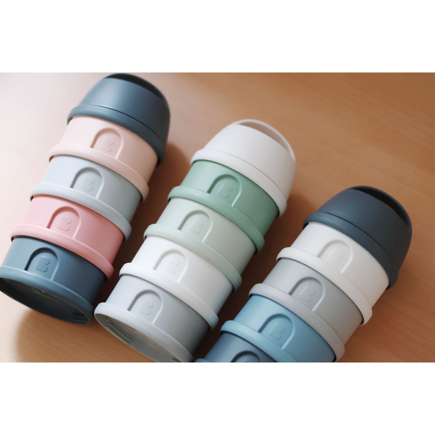 Stacked pastel-colored nesting cups from Beaba Formula and Snack Container, perfect for baby strollers