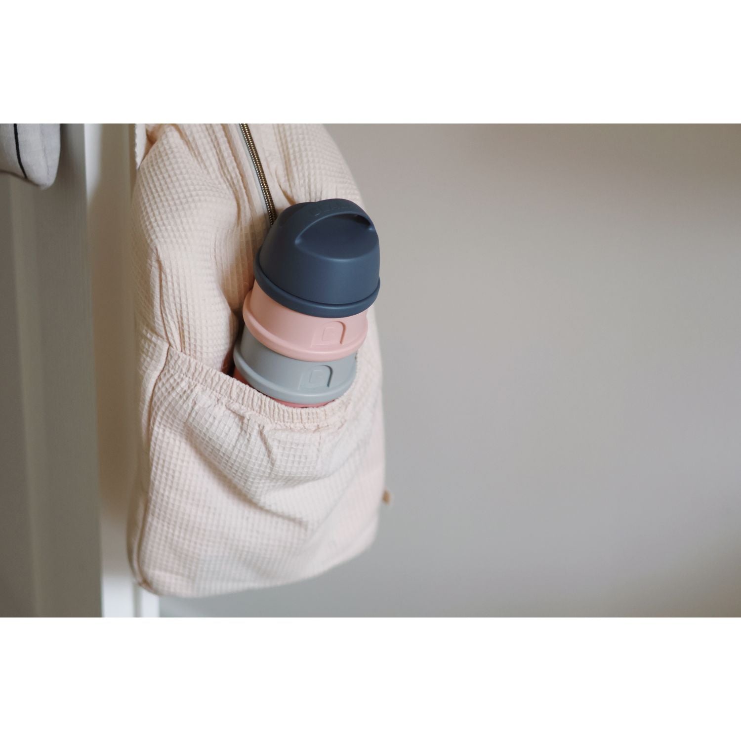 Stacked silicone snack cups in a pocket for Beaba Formula and Snack Container, perfect for on-the-go baby essentials
