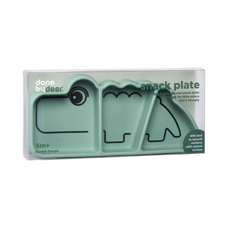Green dinosaur-shaped deer silicone stick & stay snackplate Croco Green in packaging for baby strollers