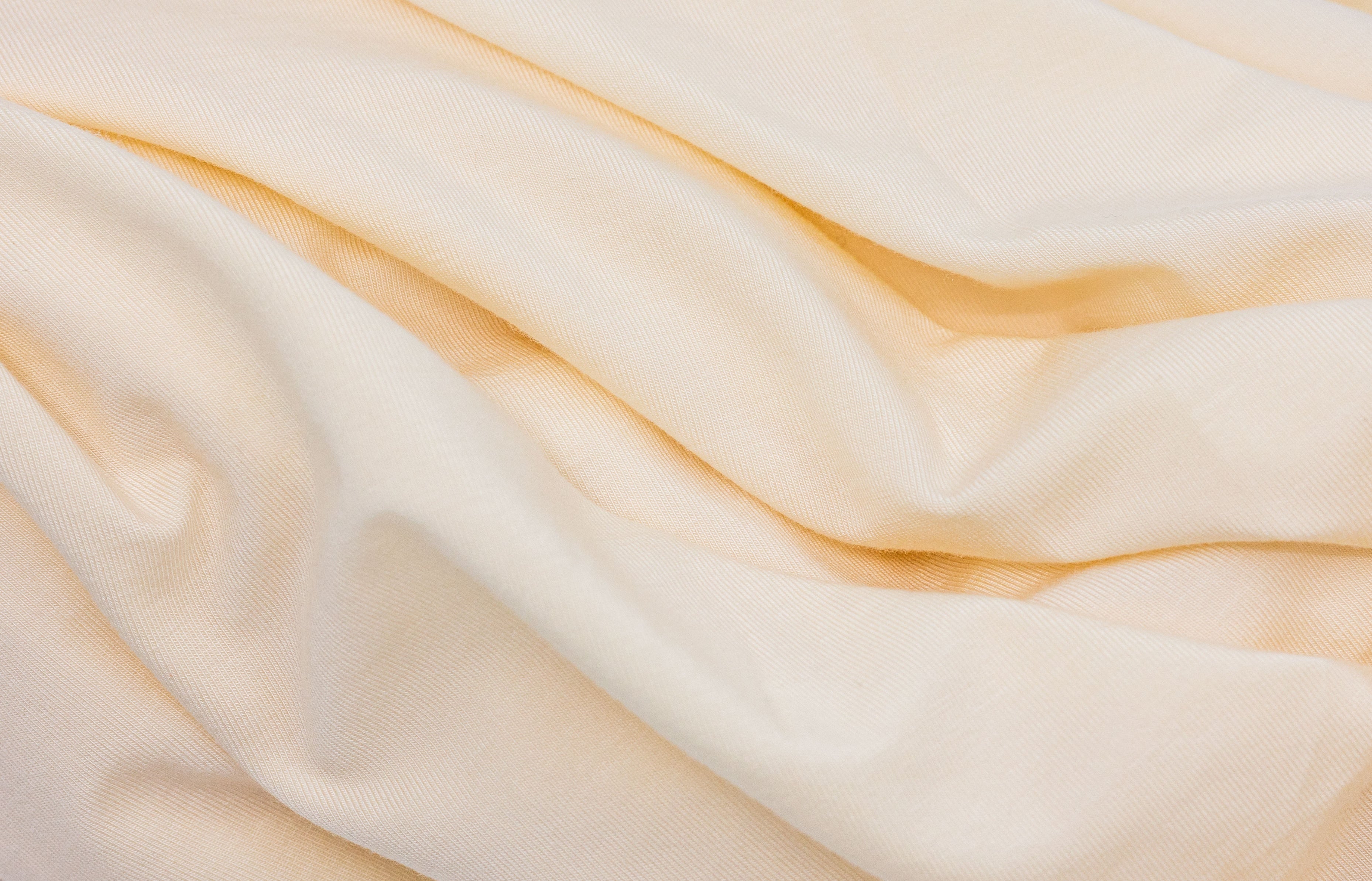 Wrinkled light yellow Tasman Eco Fitted sheet perfect for baby strollers and more