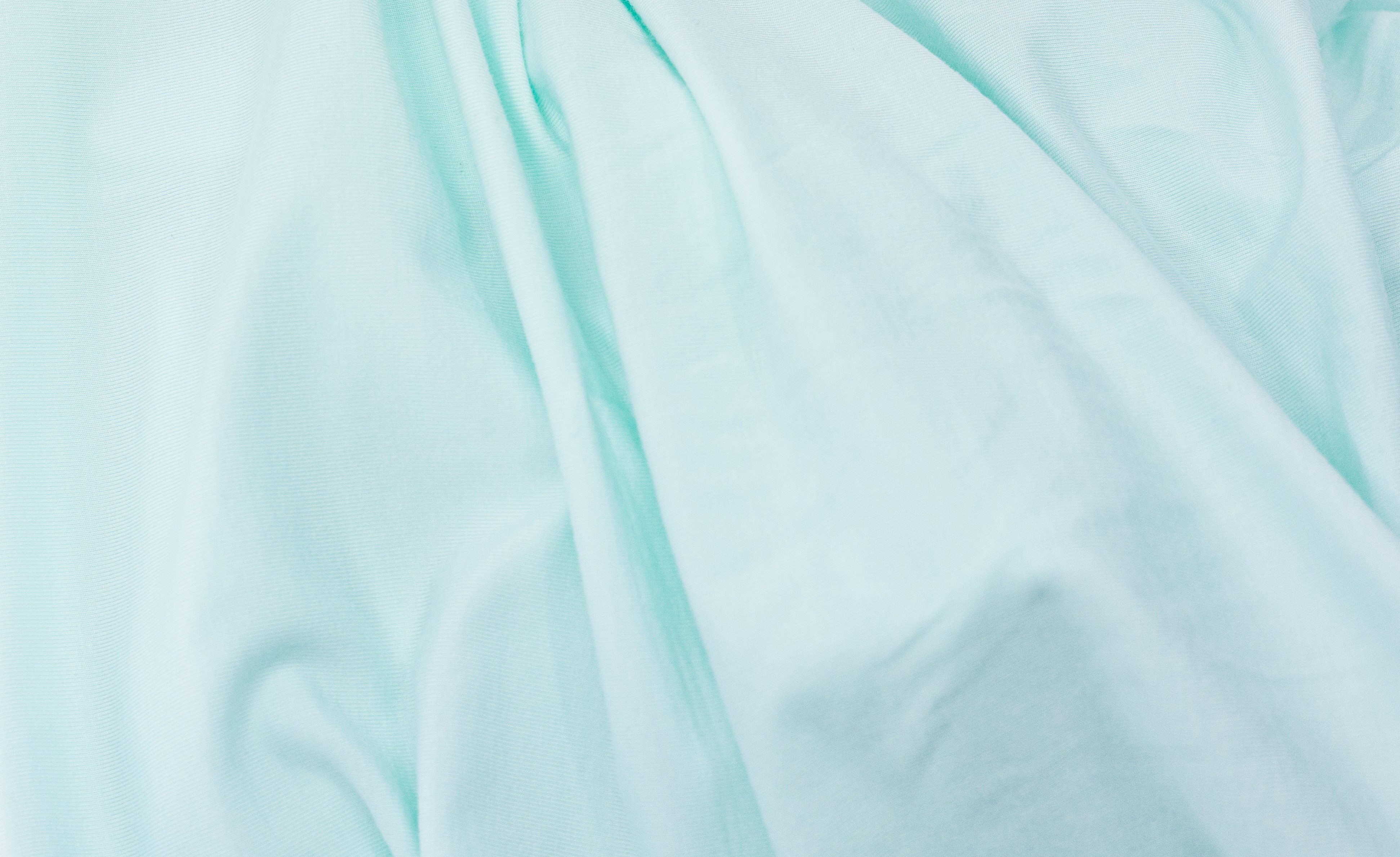 Wrinkled light blue fabric from Tasman Eco Fitted sheets perfect for baby strollers