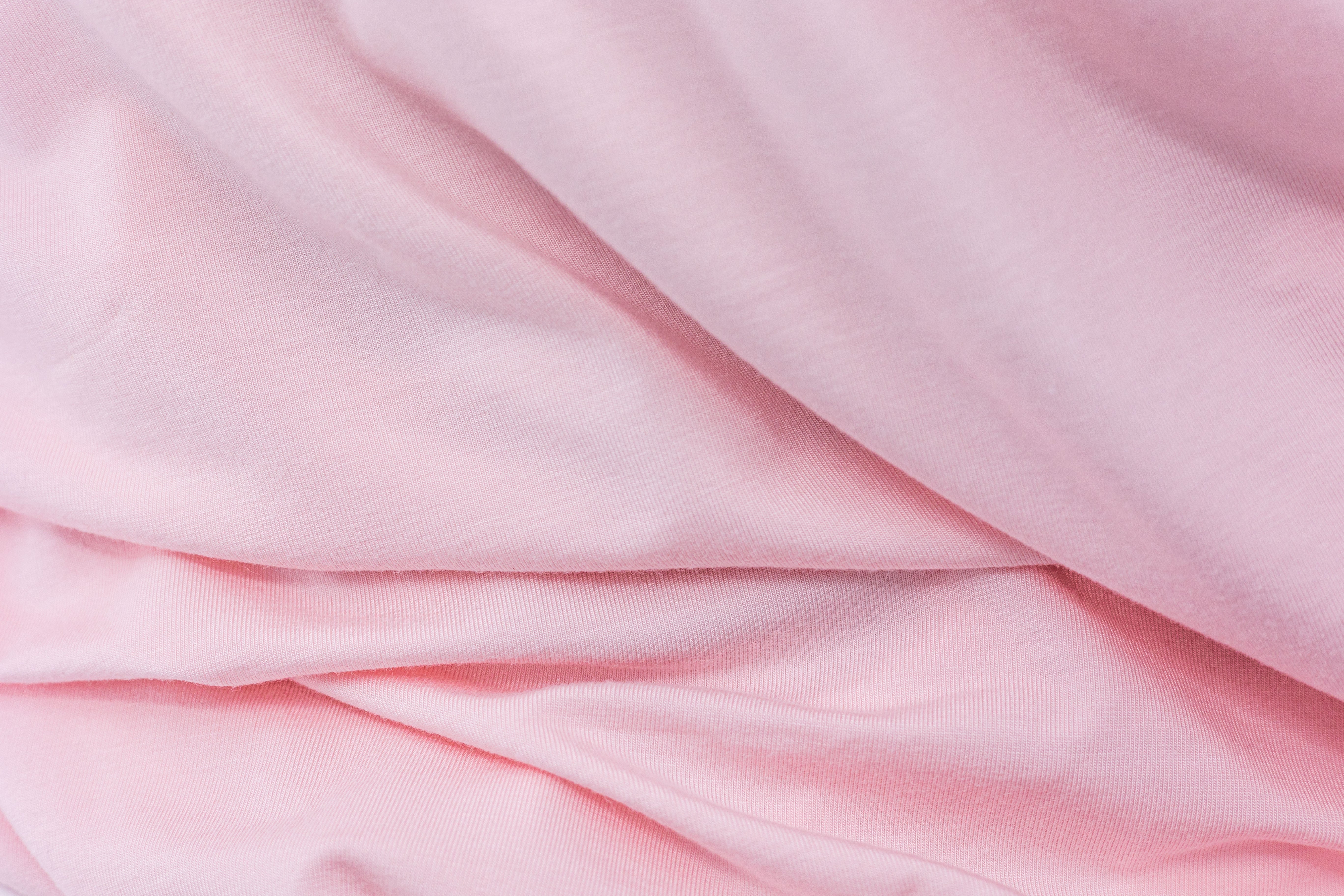 Wrinkled pink fabric from Tasman Eco Fitted sheets perfect for cozy baby rooms