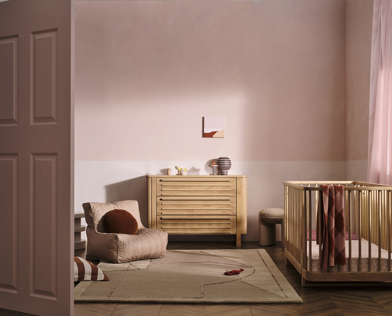 Nursery room with Tasman Eco Pisa Sandstone cot, dresser, and pocket spring mattress