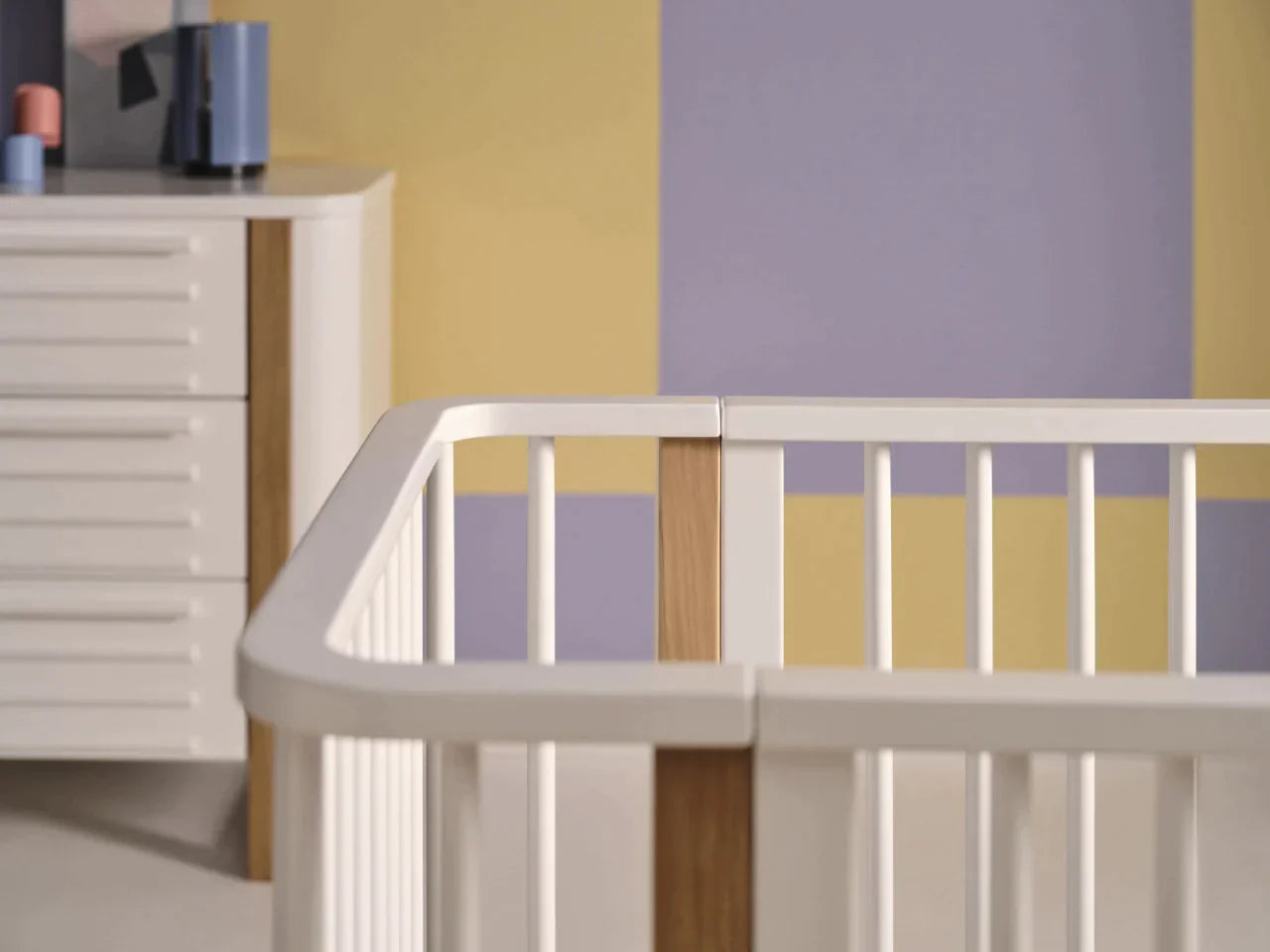 White and wood Tasman Eco Pisa baby crib with standard mattress and dresser, Toshi Baby style