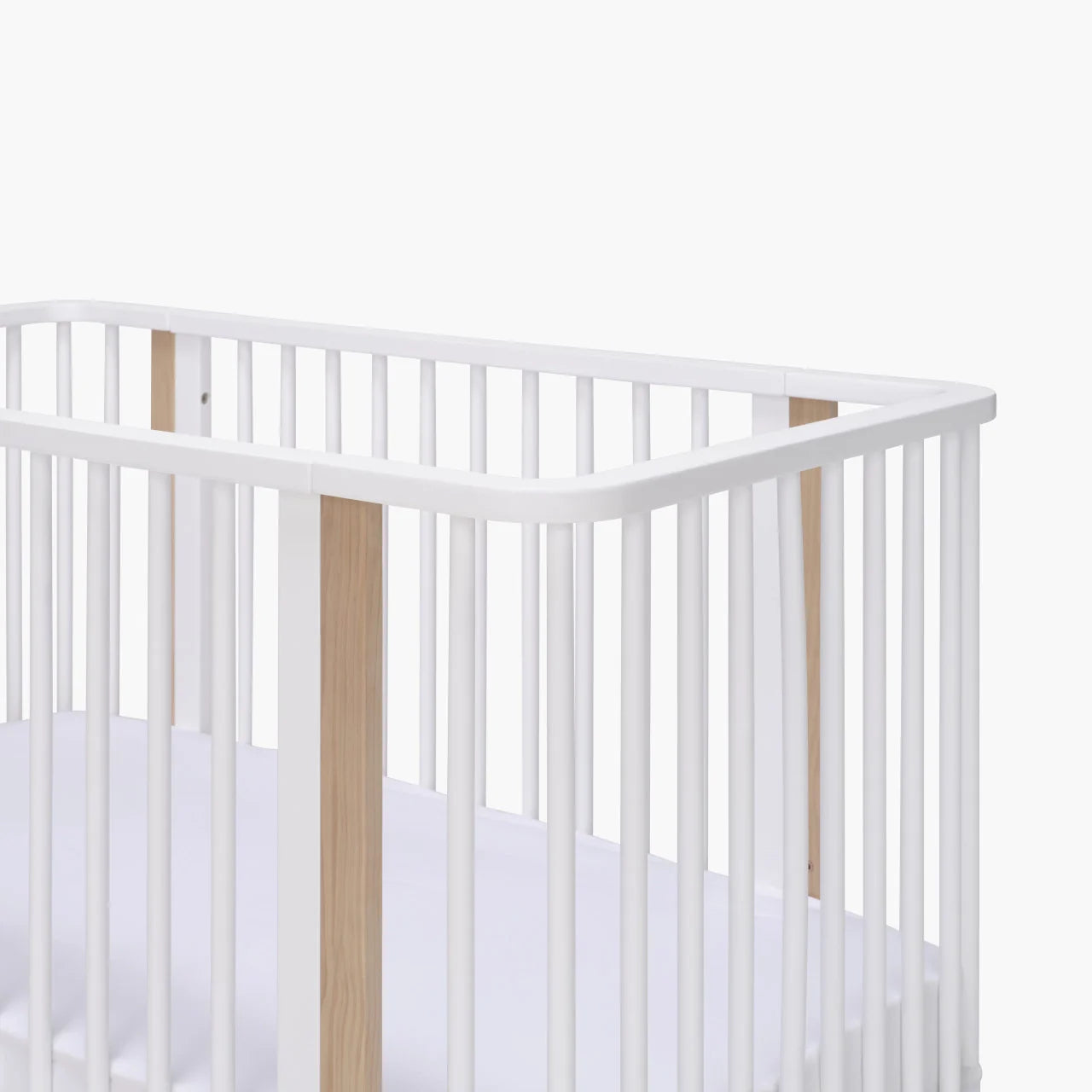 White wooden baby crib from Tasman Eco Pisa with matching dresser and Toshi Baby gear